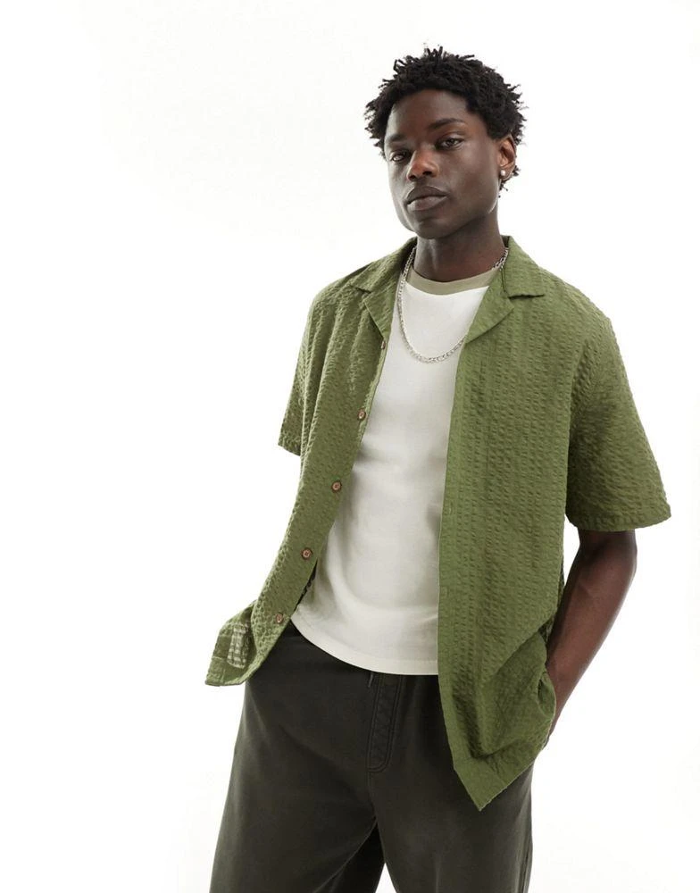 ASOS ASOS DESIGN 90s oversized short sleeve shirt in seersucker texture in khaki green 1