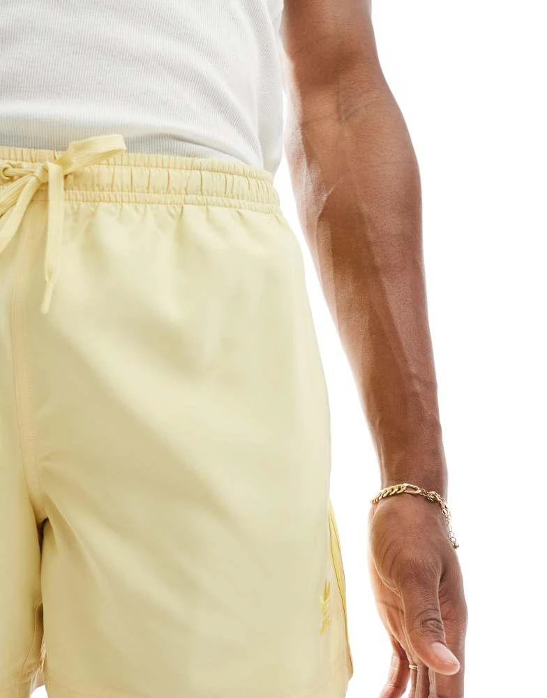 Adidas adidas Originals Adicolor 3-Stripes 5-Inch Swim Shorts in yellow 4