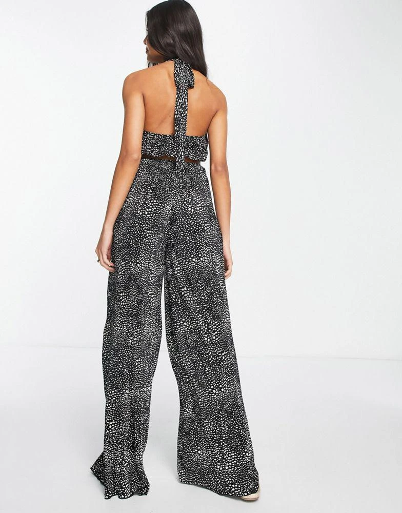 ASOS ASOS DESIGN plisse halter cut out jumpsuit with belt in spot print 2