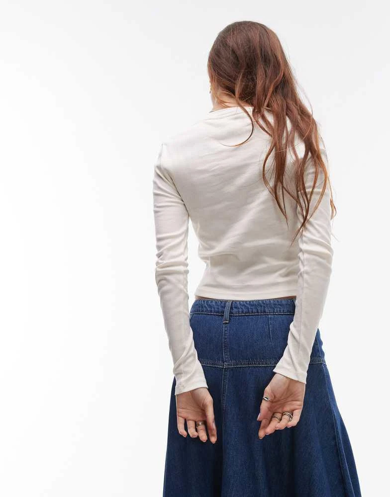 Topshop Topshop graphic saint moritz long sleeve baby tee in ivory 4