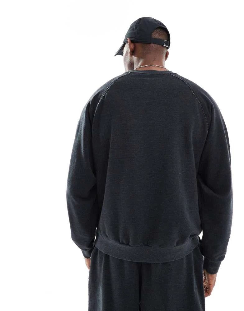 Shop Nike Training Heritage Dri-FIT fleece sweatshirt in black on