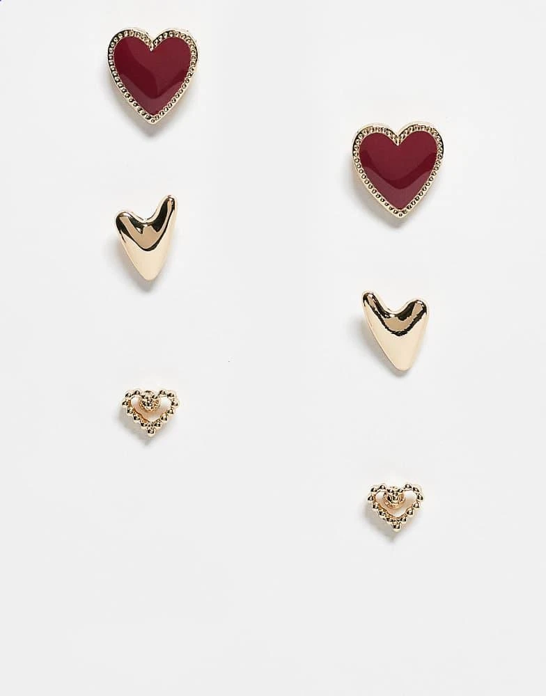 ASOS ASOS DESIGN 3 pack of stud earrings with heart design in gold and burgundy enamel