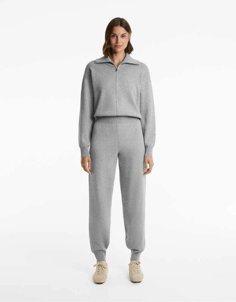 OYSHO OYSHO Half-zip long knit jumpsuit in black 1