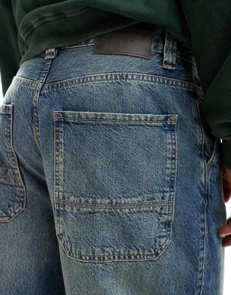 Pull&Bear Pull&Bear skater fit jean in blue with yellow cast 3