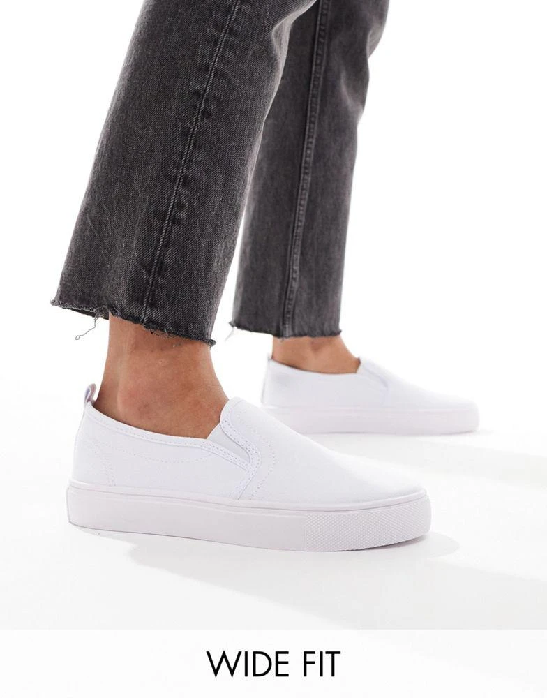 ASOS ASOS DESIGN Wide Fit Dotty slip on plimsolls in white 1