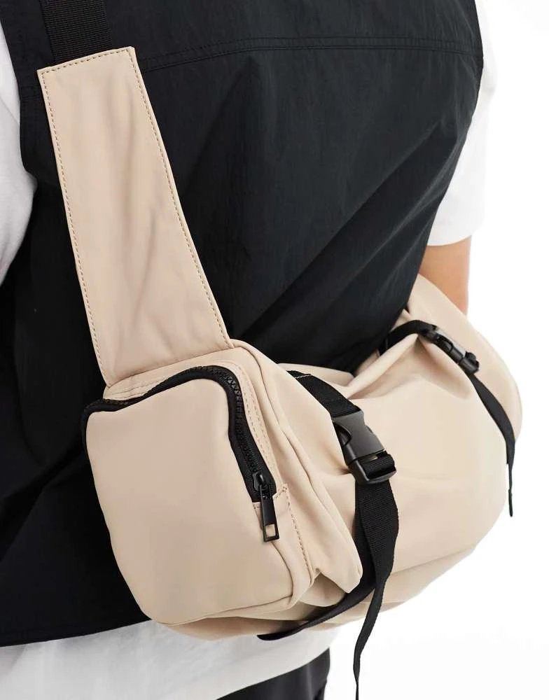 ASOS ASOS DESIGN rubberised cross body bag with pocket and buckle detail in beige 3