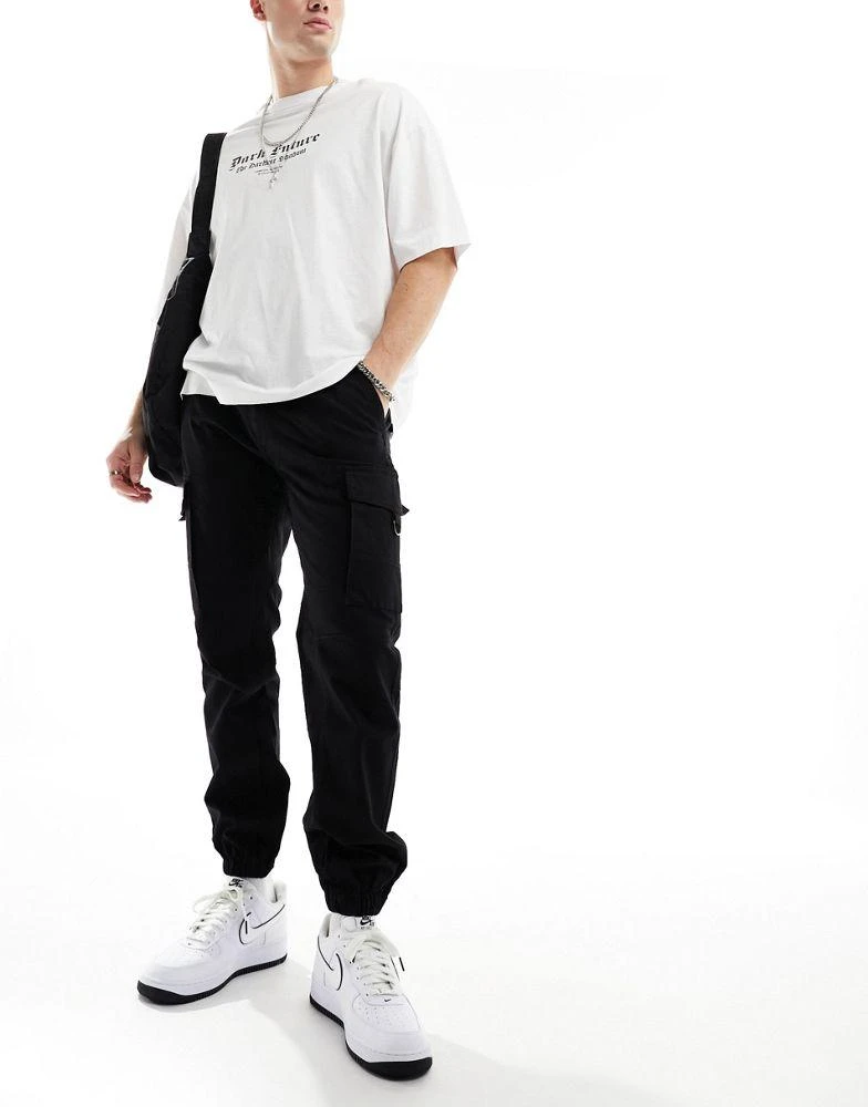 Criminal Damage Criminal Damage cuffed leg cargo pants with side leg army pockets in black 4