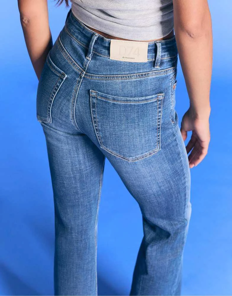 Shop Stradivarius Slit fit flared jeans in rinse blue denim on