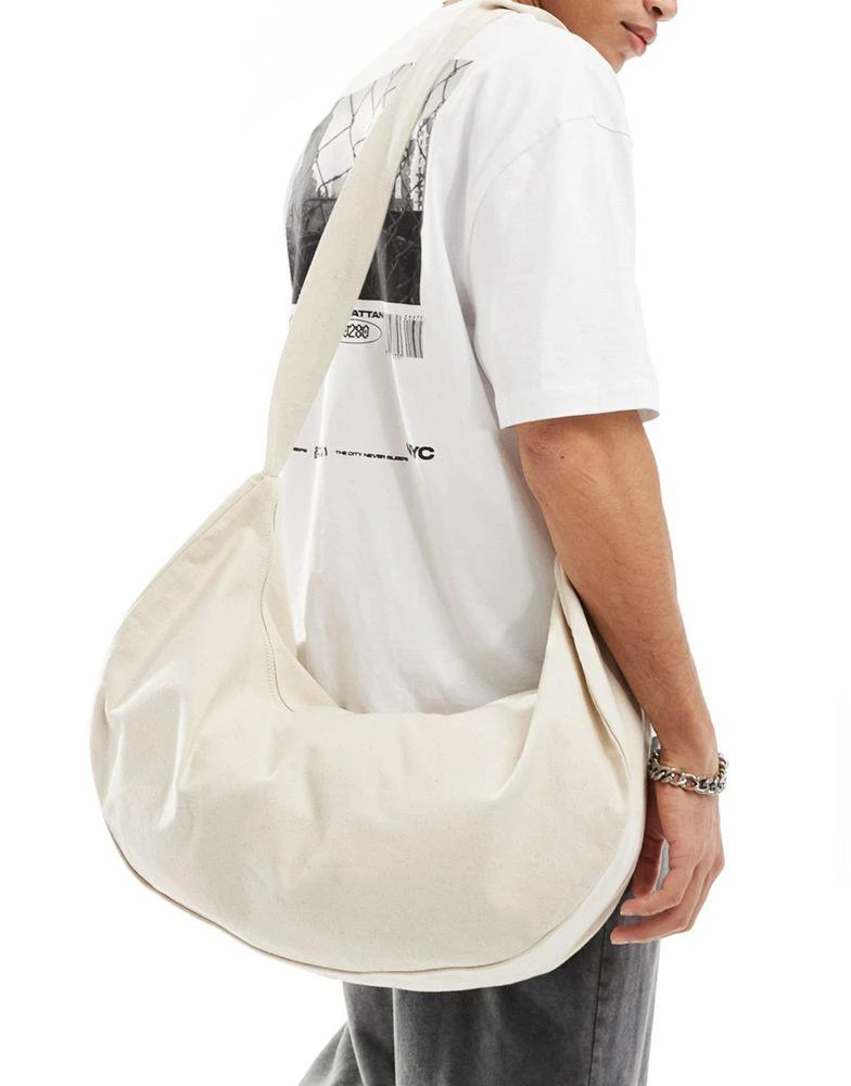 ASOS ASOS DESIGN oversized half moon sling cross body bag in ecru 2