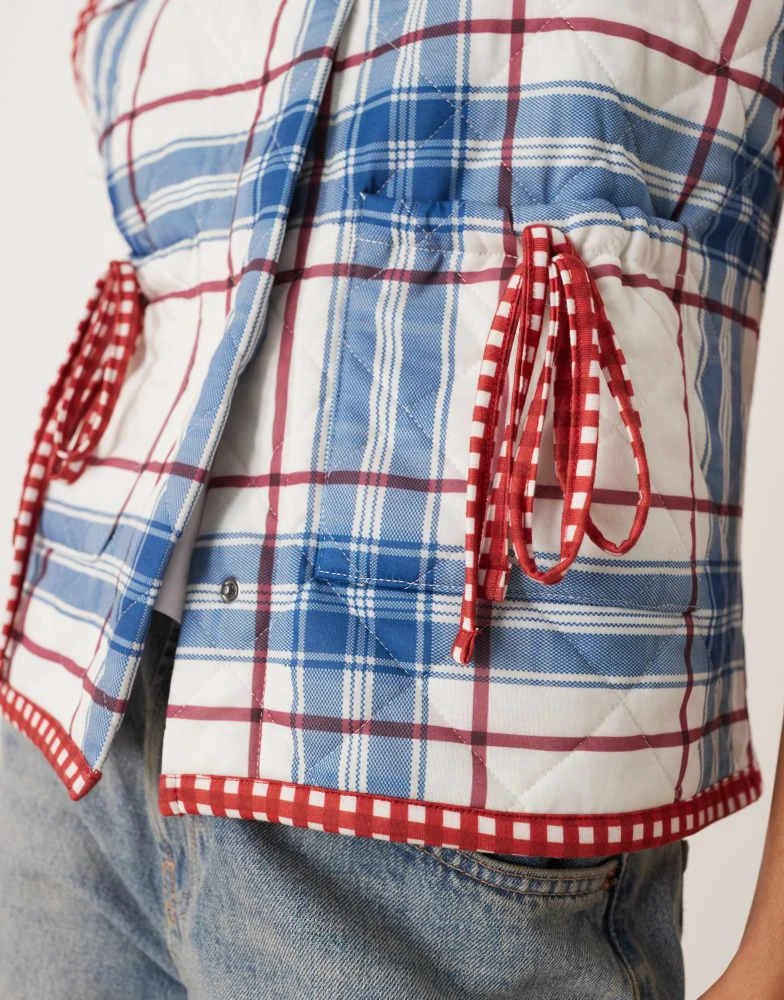 ASOS ASOS DESIGN gilet with check quilted design and bow pocket detail in blue 2