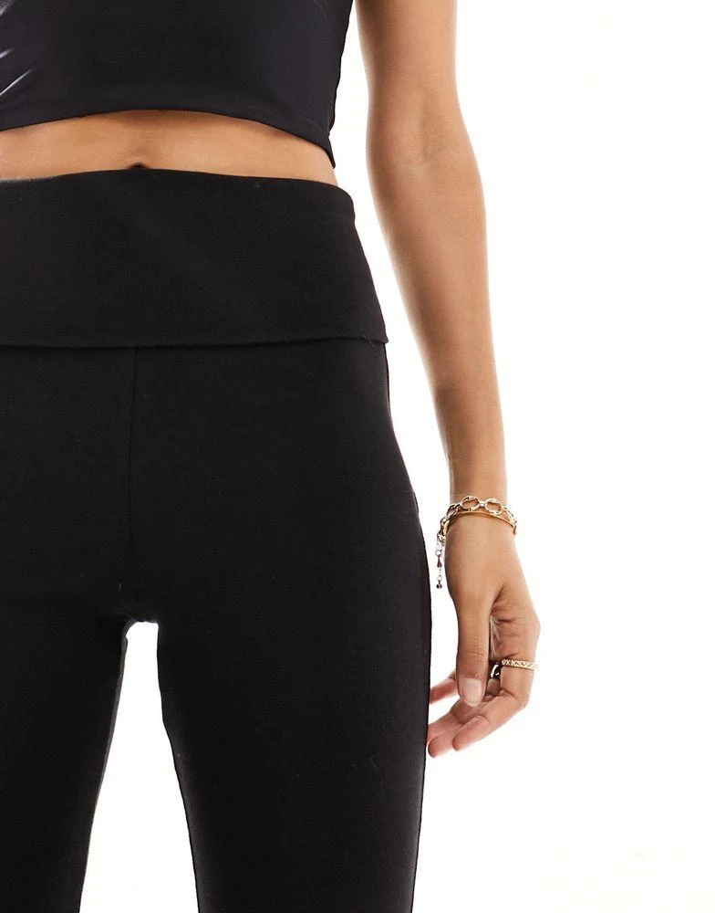 Bershka Bershka Petite folded waistband flared trousers in black 5