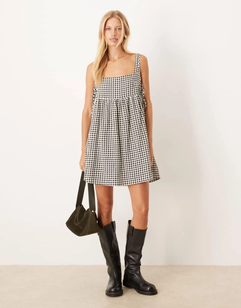 ASOS Design tie sides baby doll mini dress in Black gingham