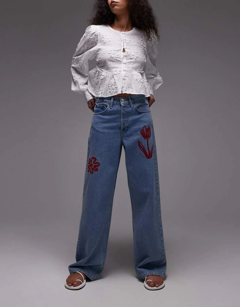 Topshop Topshop mid rise loose fit jean with red floral embroidery in mid blue 1