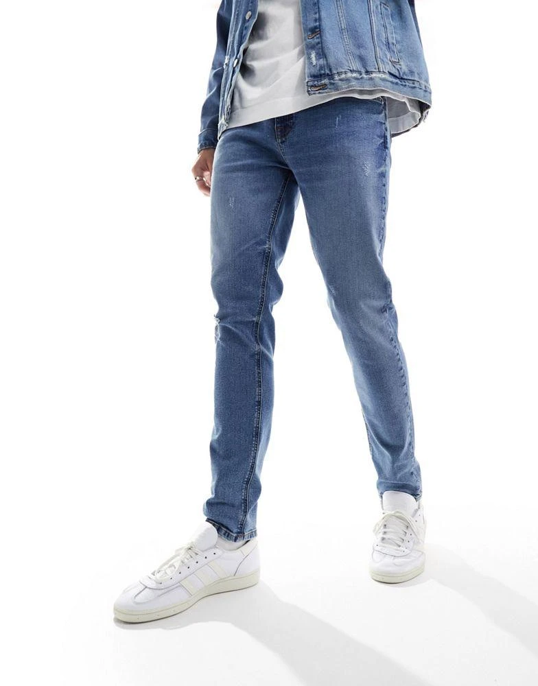 ASOS ASOS DESIGN skinny jeans with knee rip in dark wash blue 3
