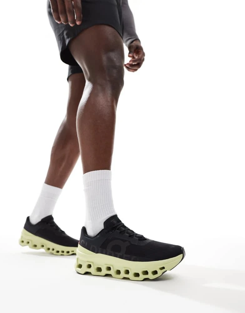 On ON Cloudmonster running trainers in black and lime green 5
