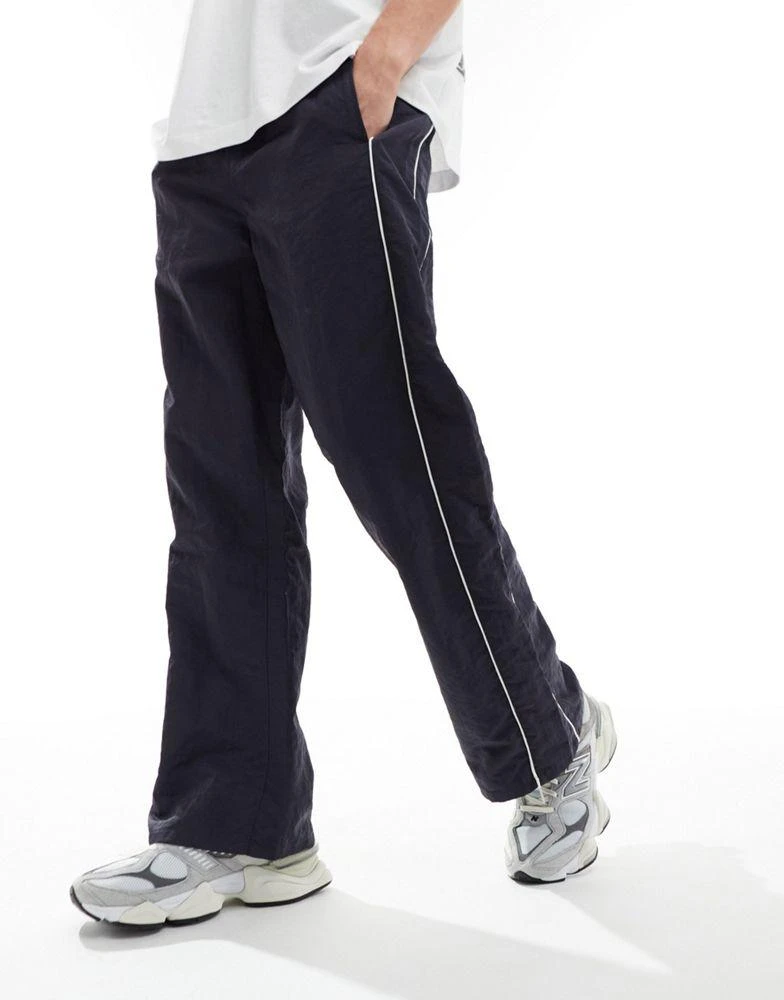 ASOS ASOS DESIGN baggy nylon track pants with white piping in navy 2