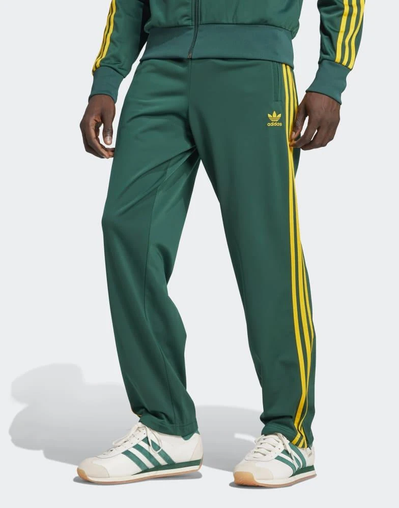 Adidas adidas Originals Firebird track pants in green and yellow 1