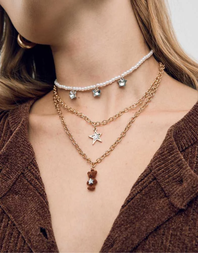 Stradivarius Stradivarius Set of 3 teddy bear necklaces in gold from ASOS