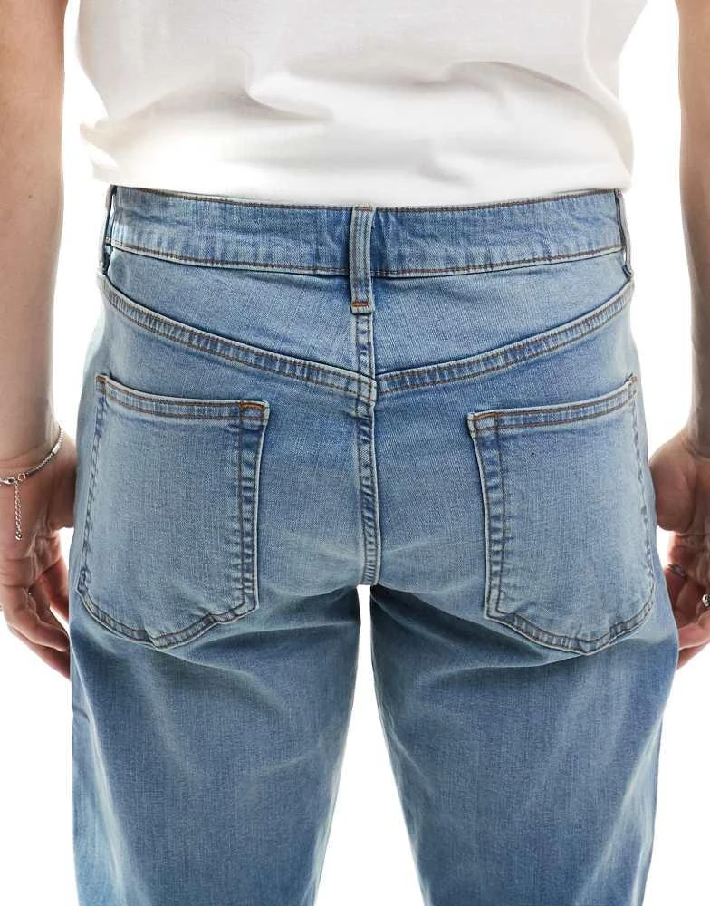 ASOS ASOS DESIGN skinny jeans with yellow tint in mid wash blue 4