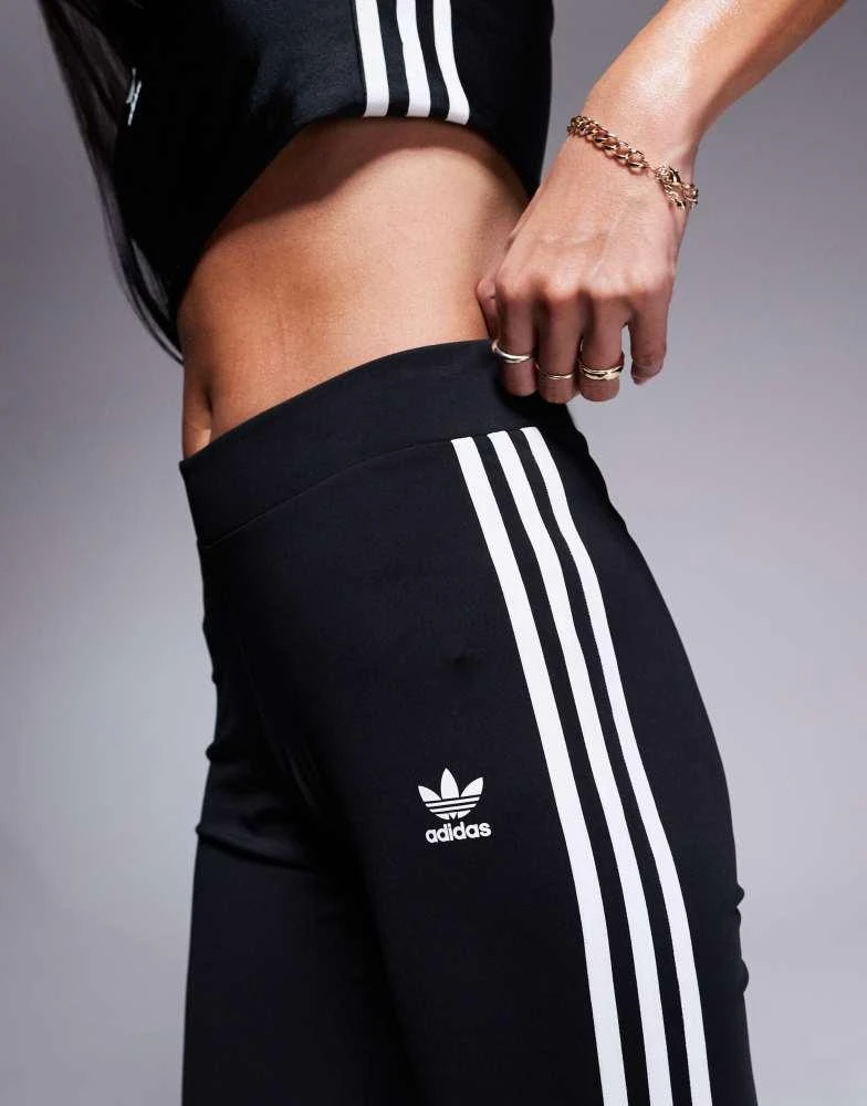 Shop adidas Originals three stripe flared leggings in black on Sale at  BeyondStyle  Get 11% Off adidas Originals three stripe flared leggings in  black with Limited-Time Flash Deals, Exclusive Discounts, and