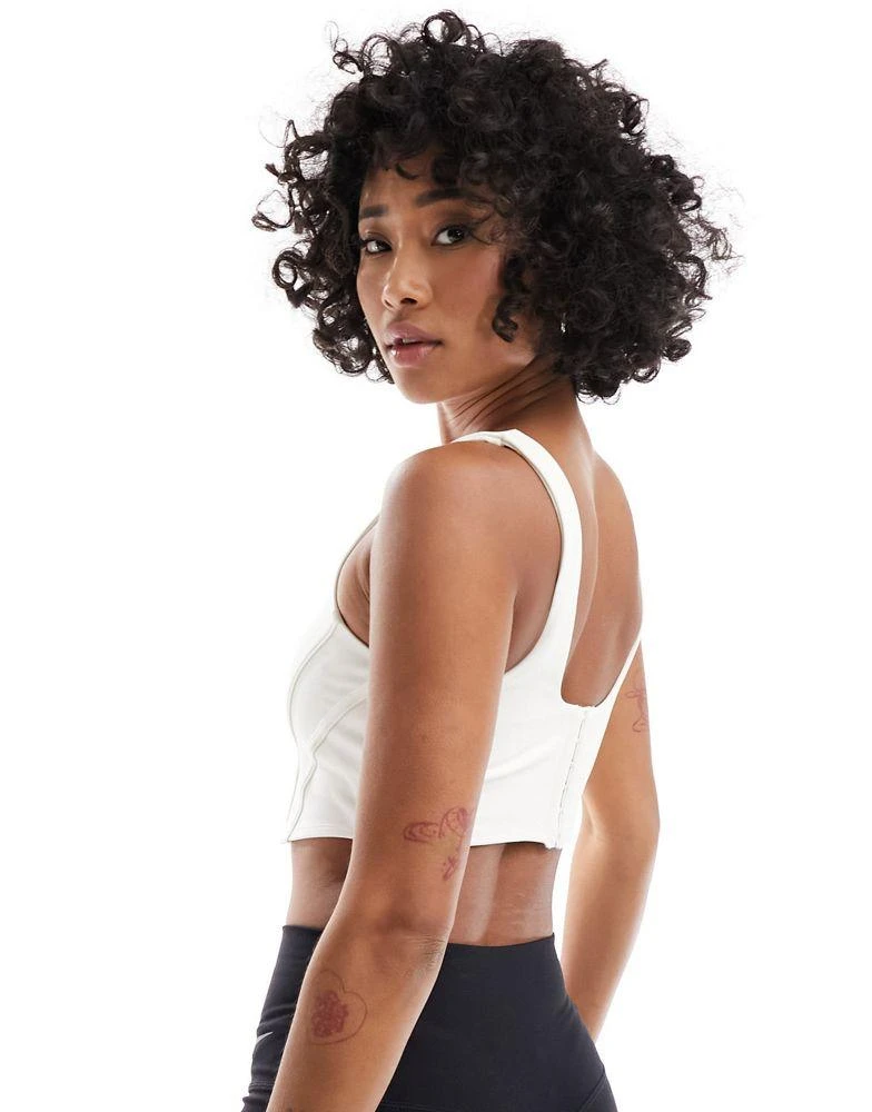 NIKE Nike Training swoosh corset light support sports bra in white - WHITE 4