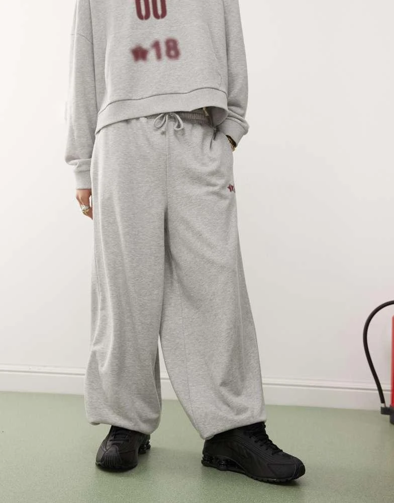 Shop COLLUSION overszied cuffed joggers with burgundy print co-ord