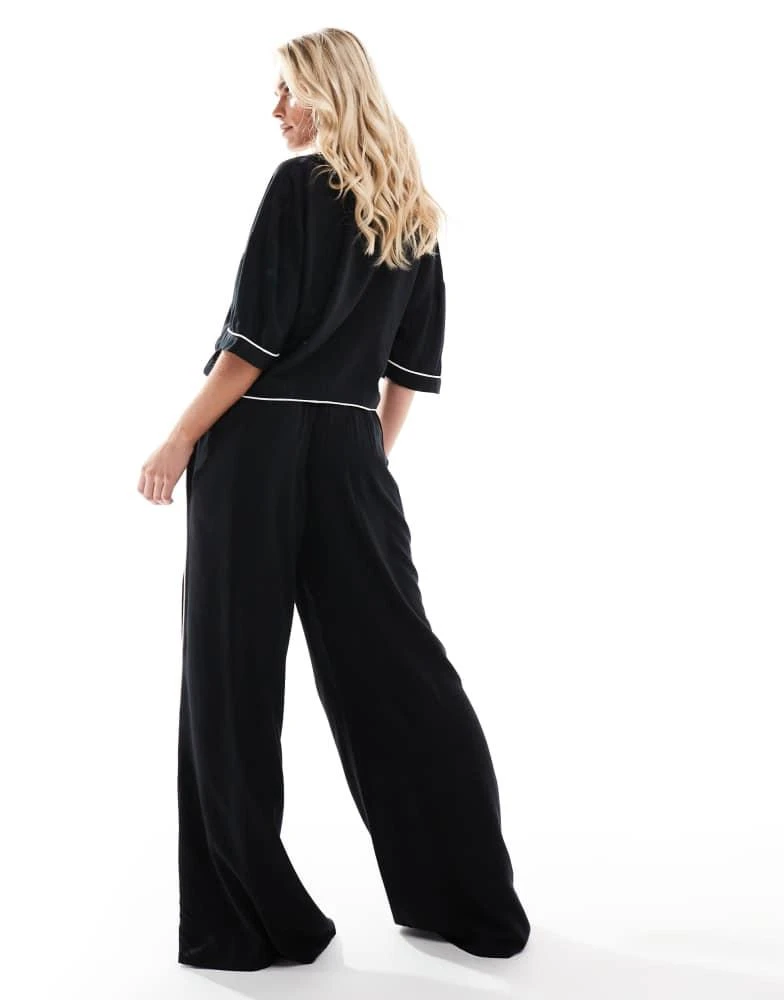 ASOS ASOS DESIGN Petite super soft slinky wide leg pyjama trouser in black with contrast binding 3