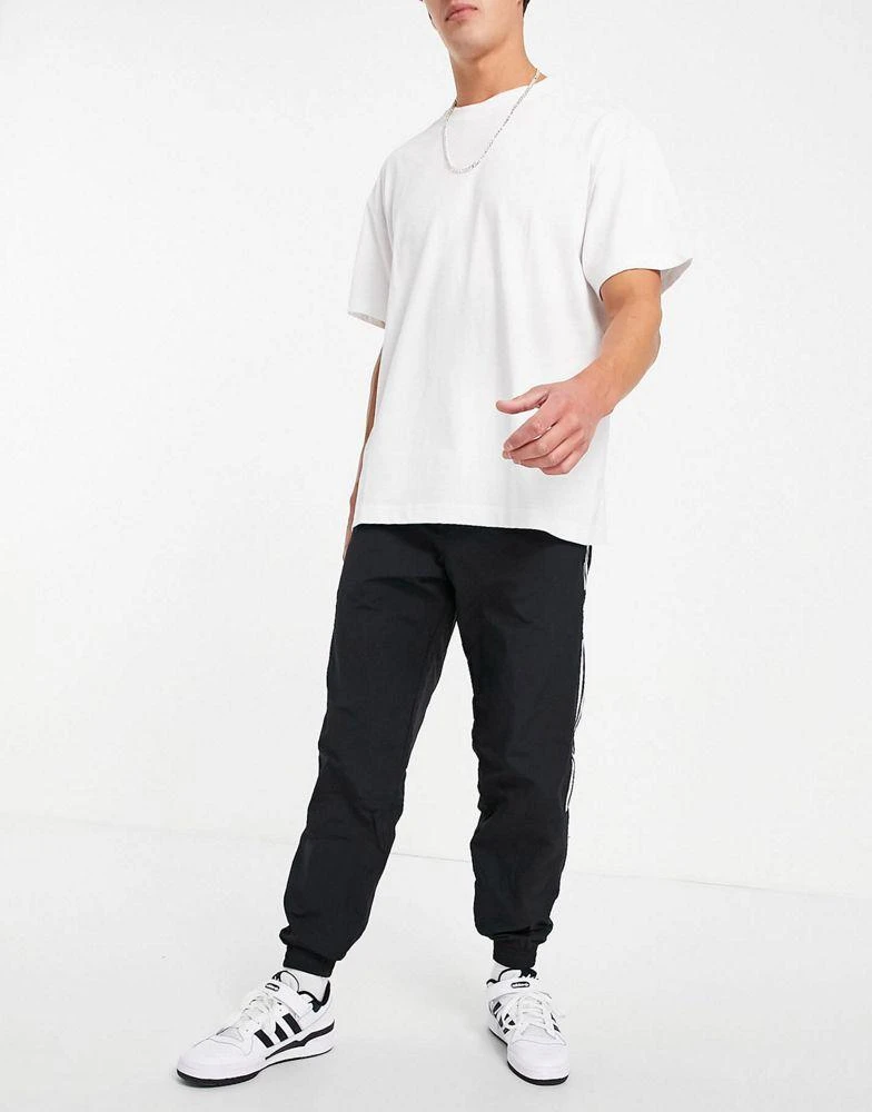 Adidas adidas Originals adicolor lock up joggers in black 2