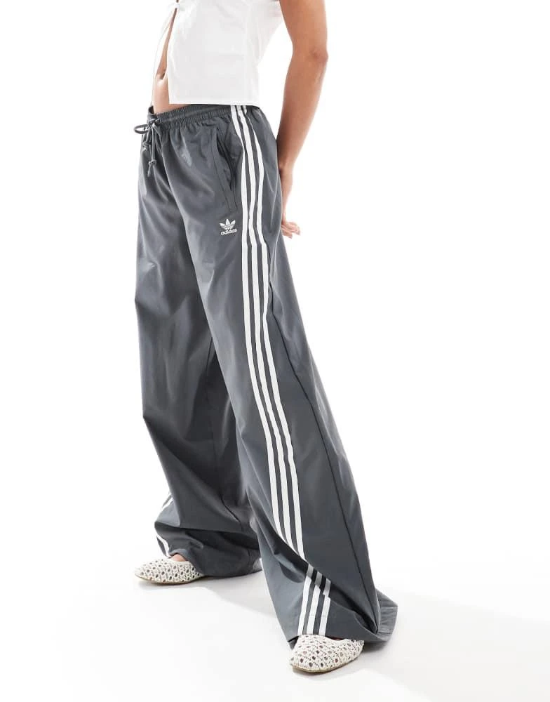 Shop adidas Originals three stripe oversized track pants in grey
