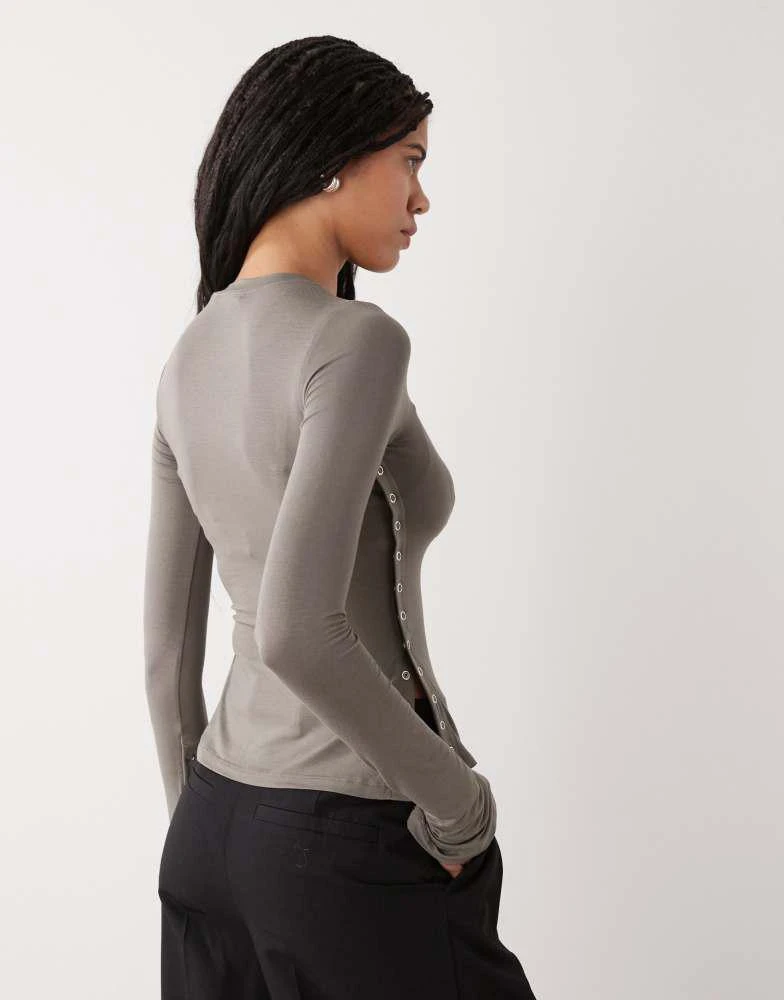 Weekday Weekday long sleeve fitted top with button detailing and asymmetric hem in grey 3