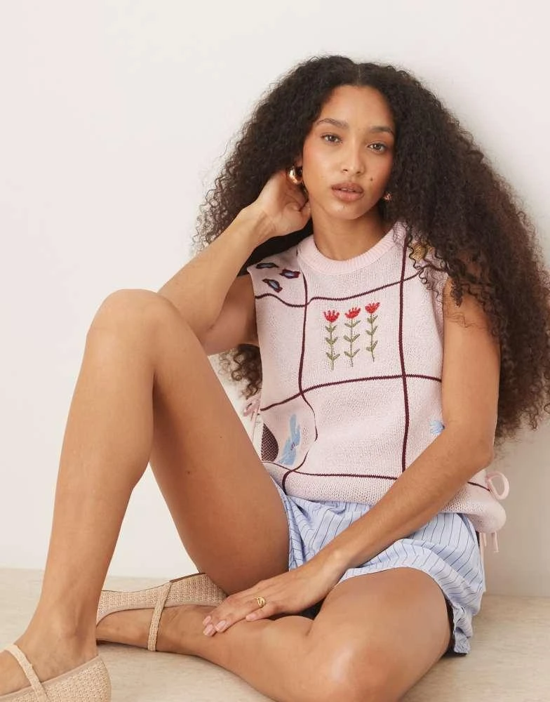 ASOS ASOS DESIGN crew neck knit tabard vest with floral embroidery in pink 1