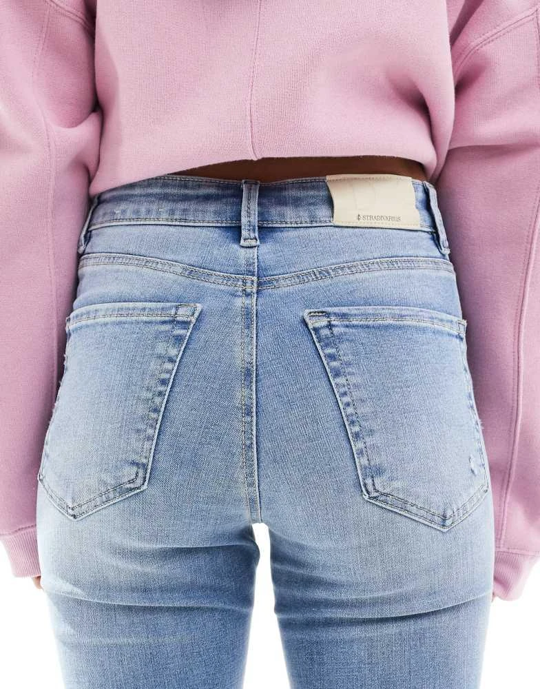 Stradivarius Stradivarius D74 flare slit jean in medium wash 4