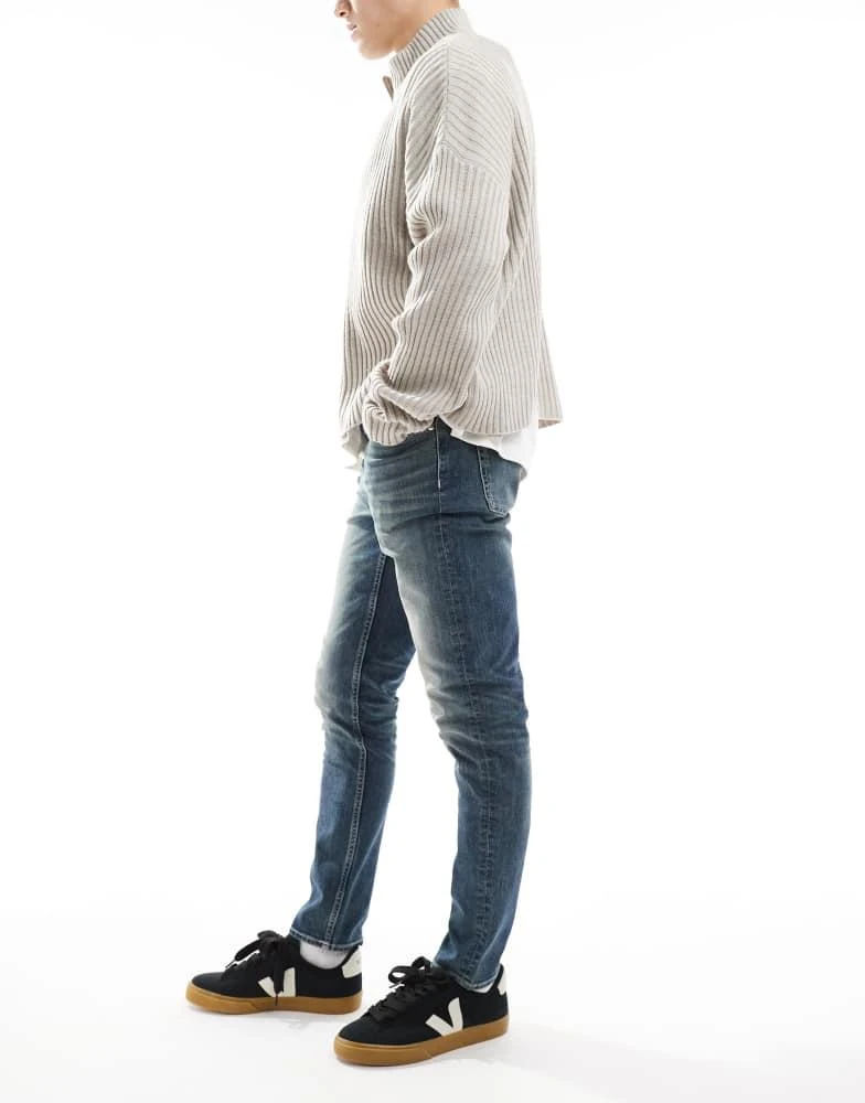 ASOS ASOS DESIGN skinny jeans with green tint in light wash blue 2
