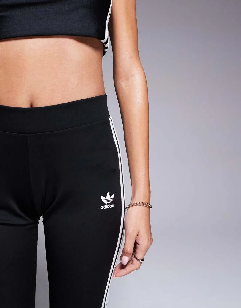 Shop adidas Originals three stripe flared leggings in black on Sale at  BeyondStyle  Get 11% Off adidas Originals three stripe flared leggings in  black with Limited-Time Flash Deals, Exclusive Discounts, and