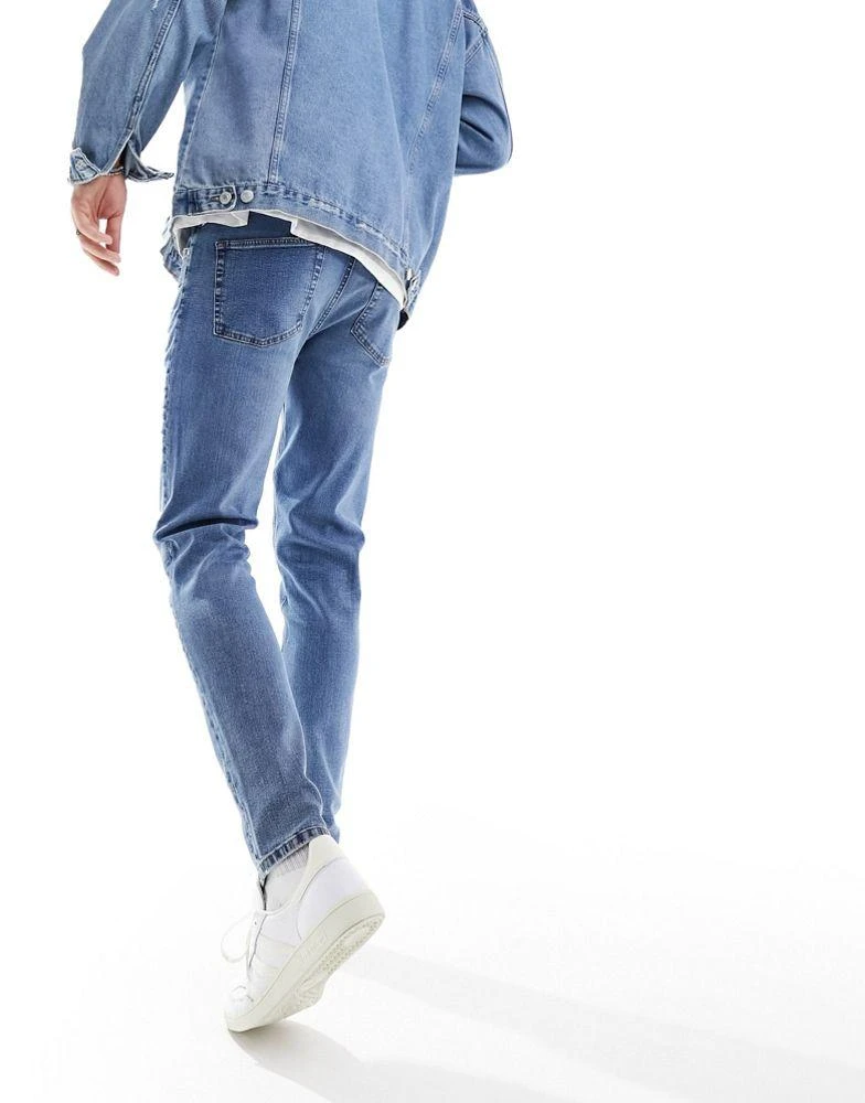 ASOS ASOS DESIGN skinny jeans with knee rip in dark wash blue 5