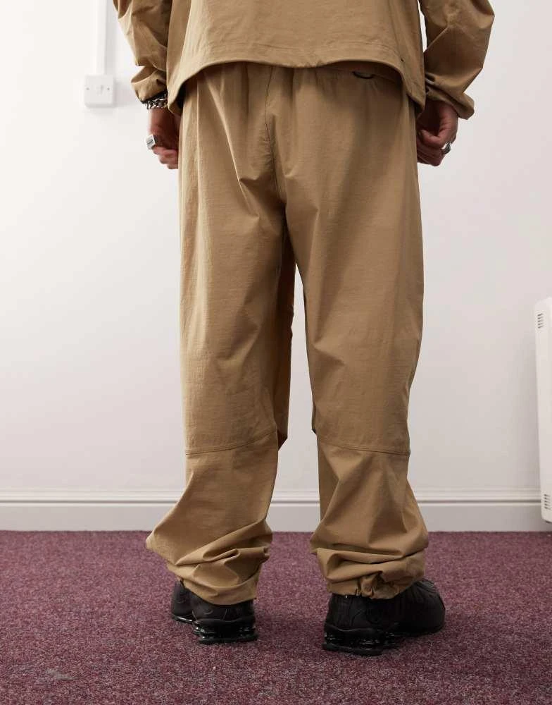 NIKE Nike Tech woven trouser in beige 3