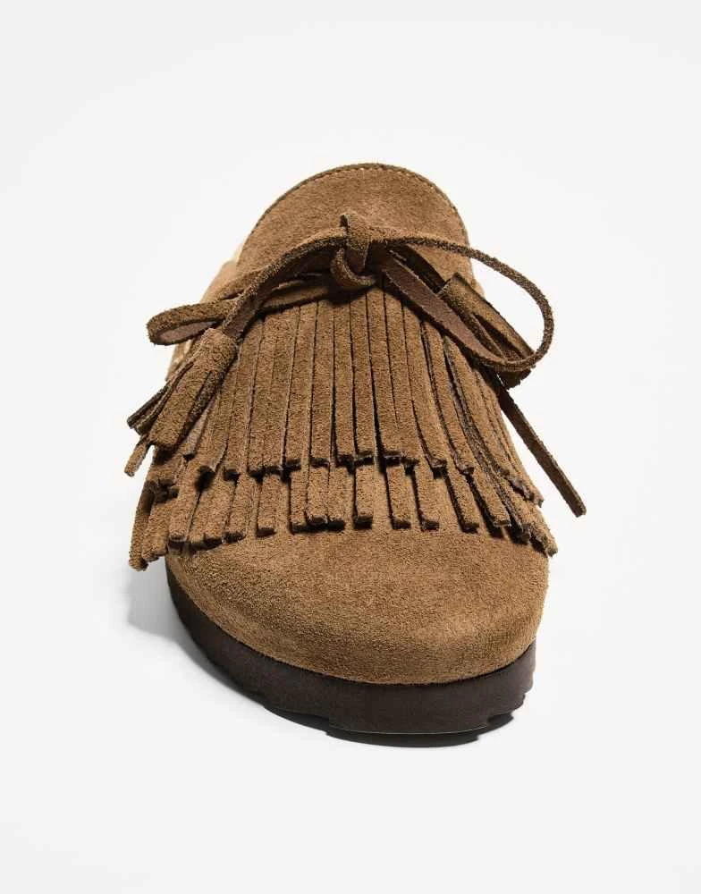 Shop Bershka flat leather clogs with fringe detailing in brown on