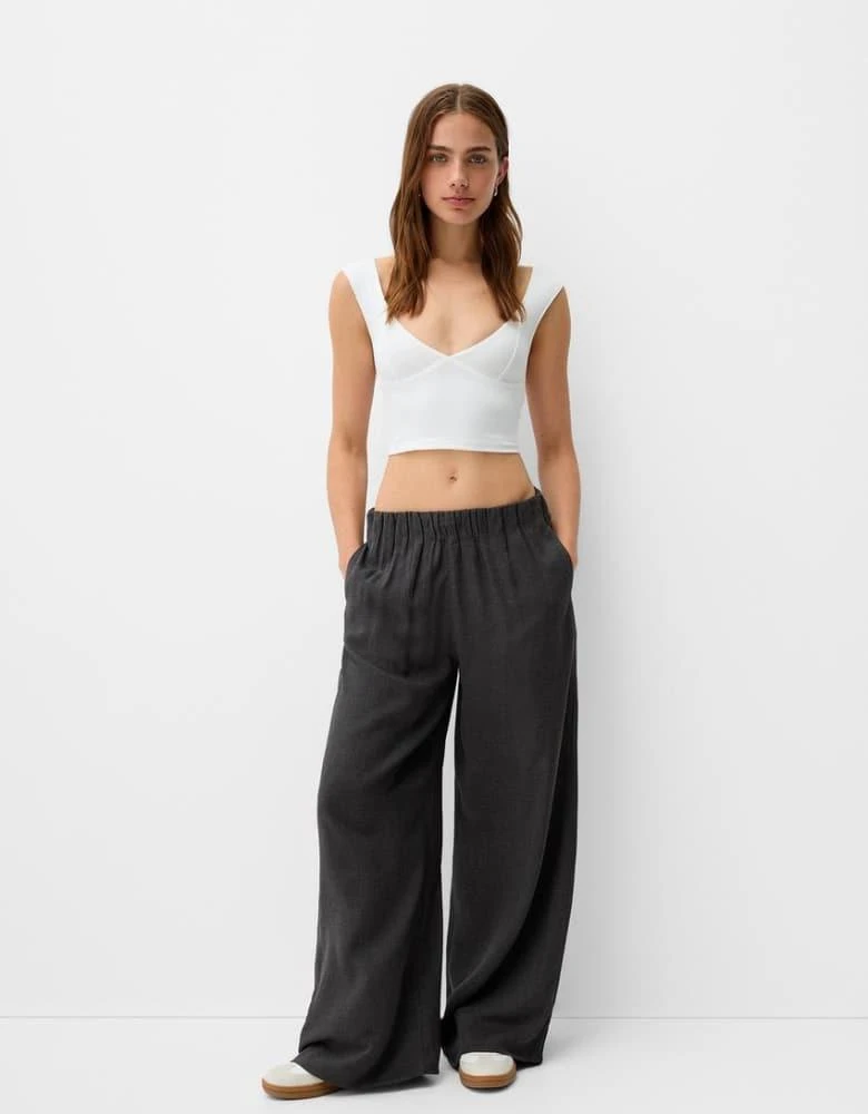 Bershka Bershka Petite drawstring waist wide leg trousers in dark grey check 1