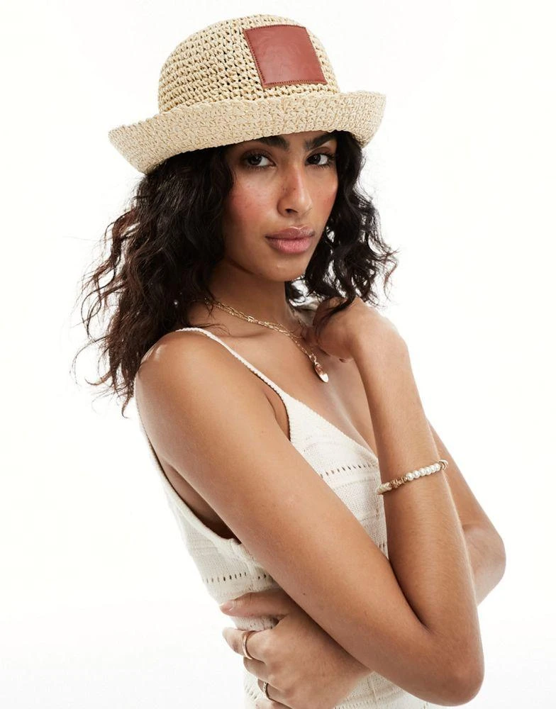 ASOS ASOS DESIGN straw crochet bucket hat with faux leather patch 1