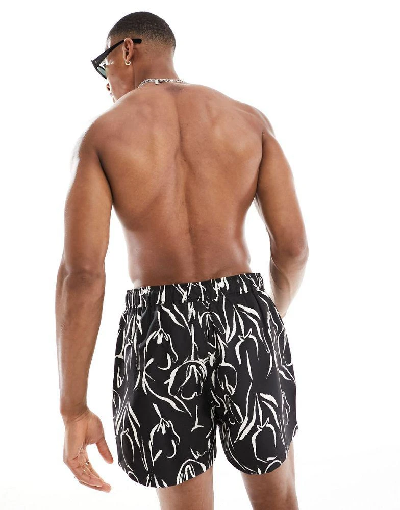 ASOS ASOS DESIGN swim shorts in short length in black and white floral print 4