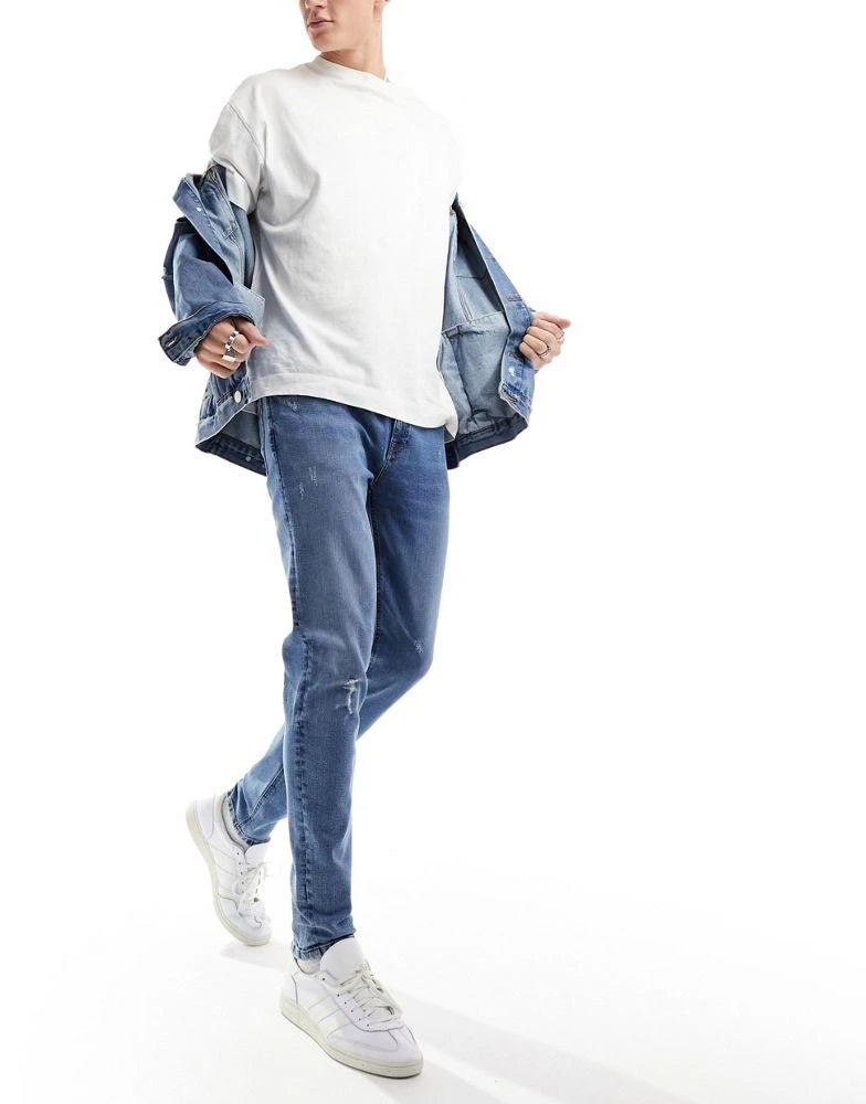ASOS ASOS DESIGN skinny jeans with knee rip in dark wash blue 1