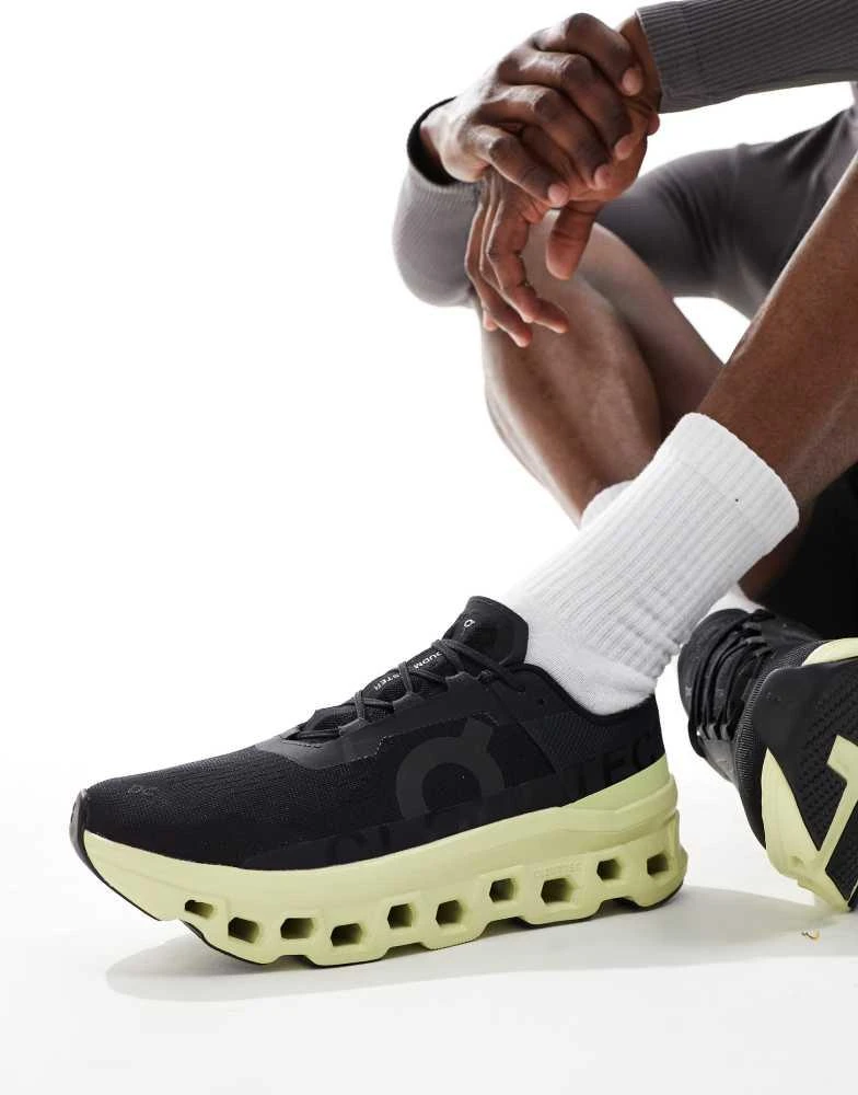 On ON Cloudmonster running trainers in black and lime green 1