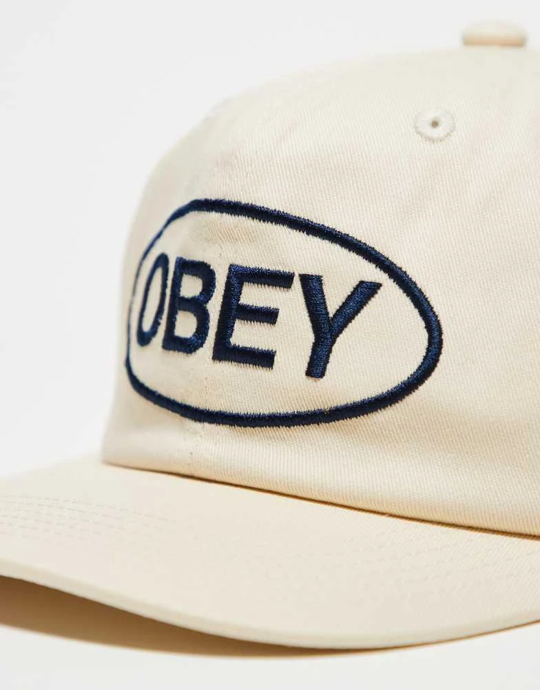 Obey Obey obey oval 6 panel strapback logo cap in off white 2