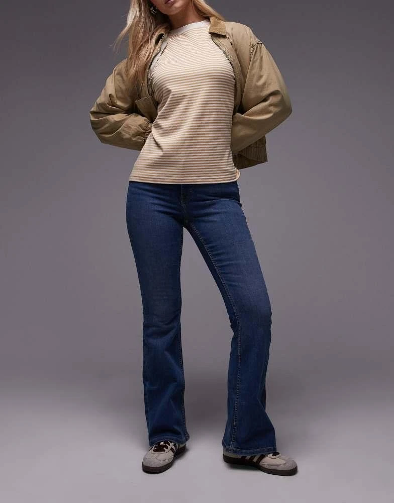 Shop Topshop Hourglass Jamie Flare high rise jeans in mid blue on