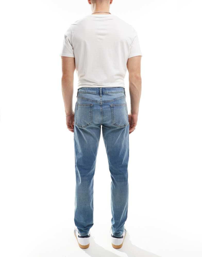 ASOS ASOS DESIGN skinny jeans with yellow tint in mid wash blue