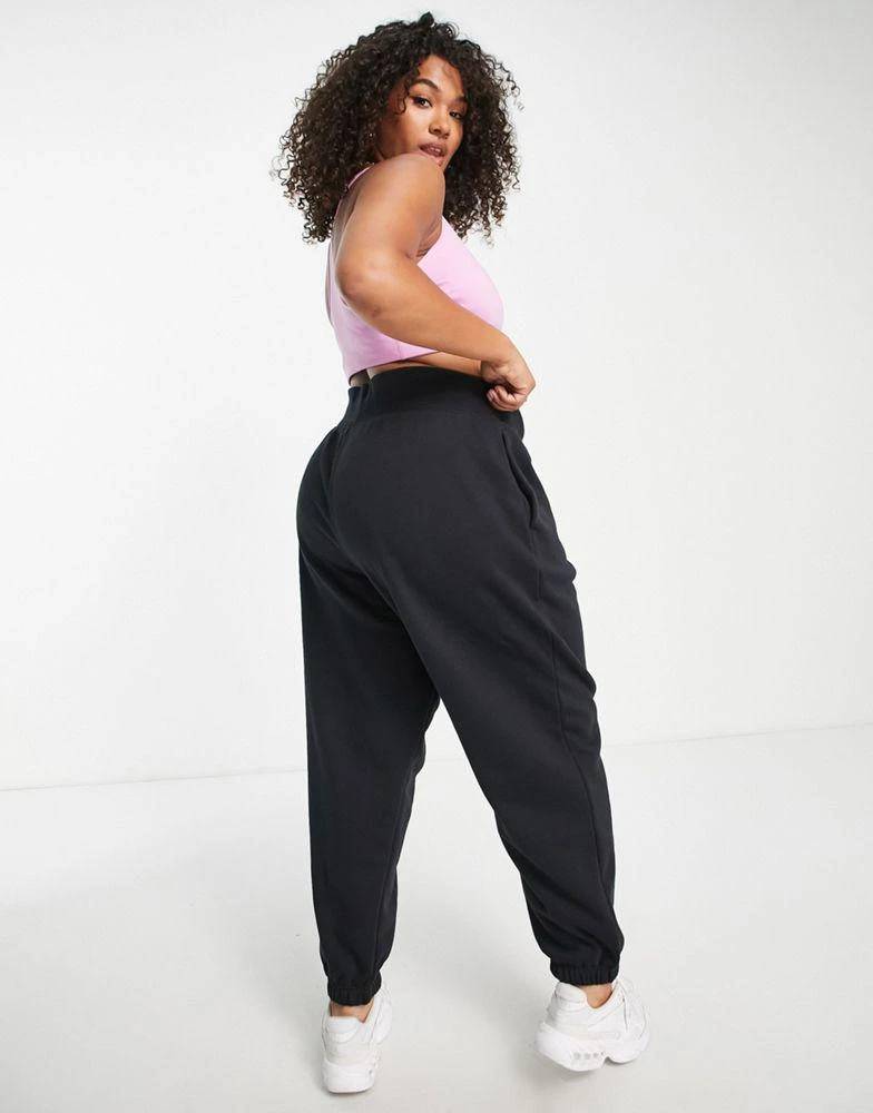 NIKE Nike Plus mini swoosh oversized high rise joggers in black and sail 2