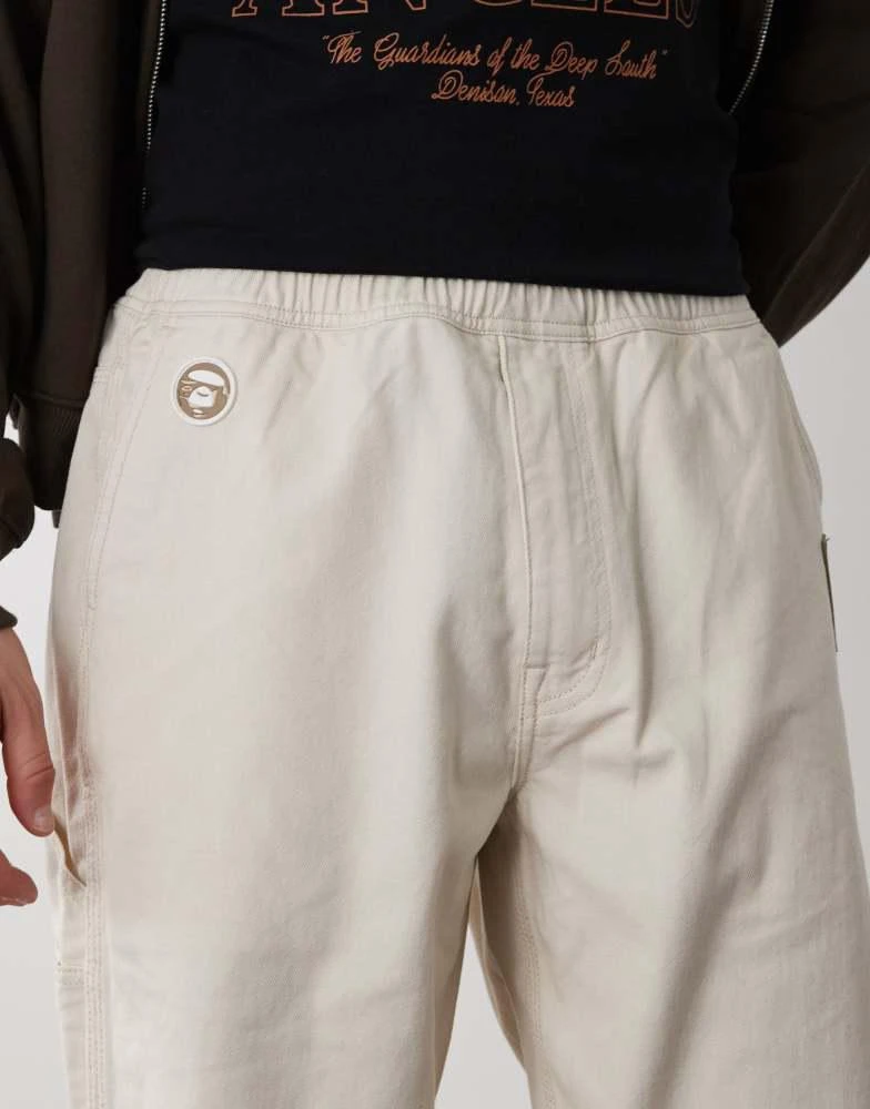 AAPE Aape by A Bathing Ape loose fit worker jeans in off white 4
