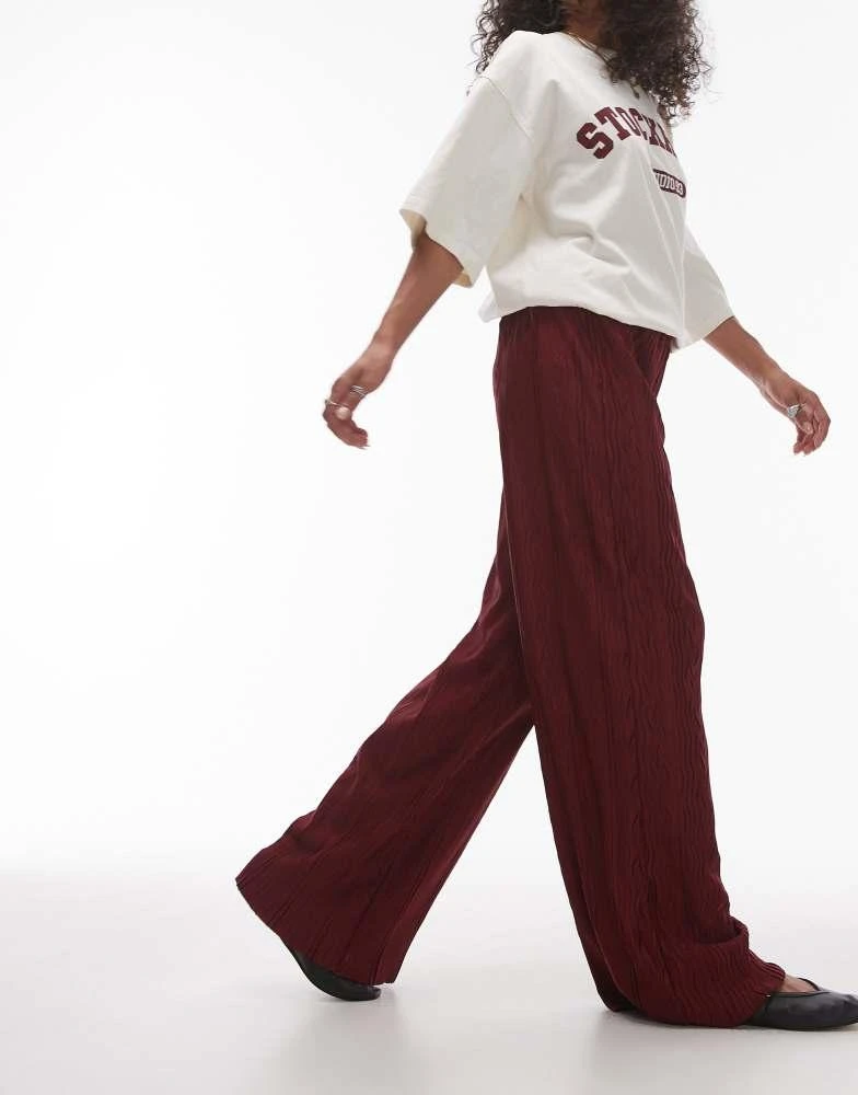 Shop Topshop crinkle plisse wide leg trouser in burgundy on Sale