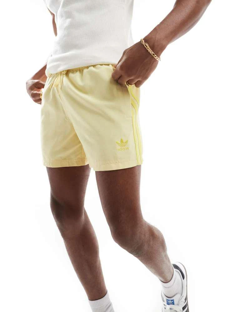 Adidas adidas Originals Adicolor 3-Stripes 5-Inch Swim Shorts in yellow 1