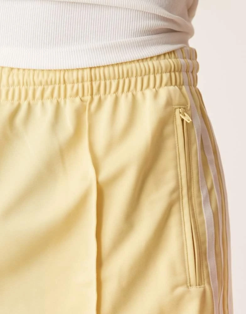 Adidas adidas Originals Firebird shorts in yellow - BeyondStyle